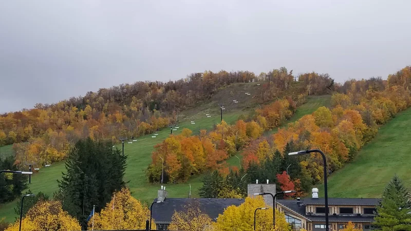 Blue Mountain chair lift ride over colorful autumn forest
