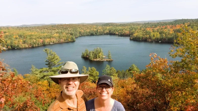 Happy couple enjoying Algonquin Park fall colours tour